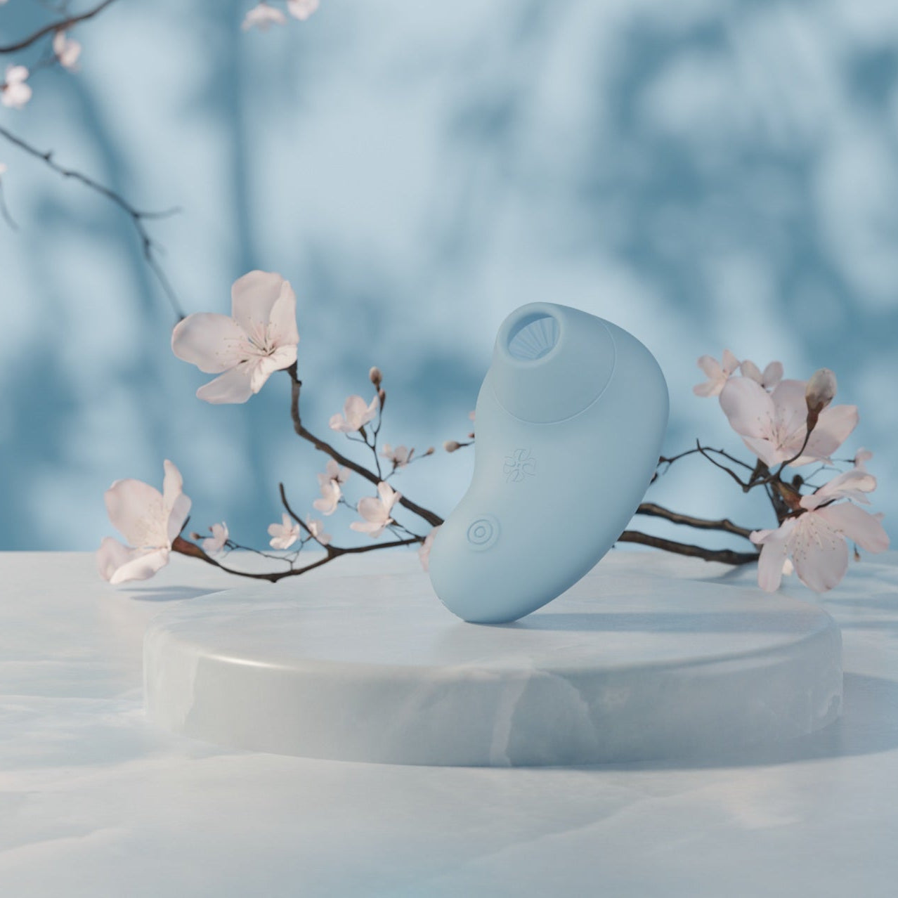 Velvet Rituals Aurora air suction and vibration massager showcased in a serene floral setting with pastel blue tones