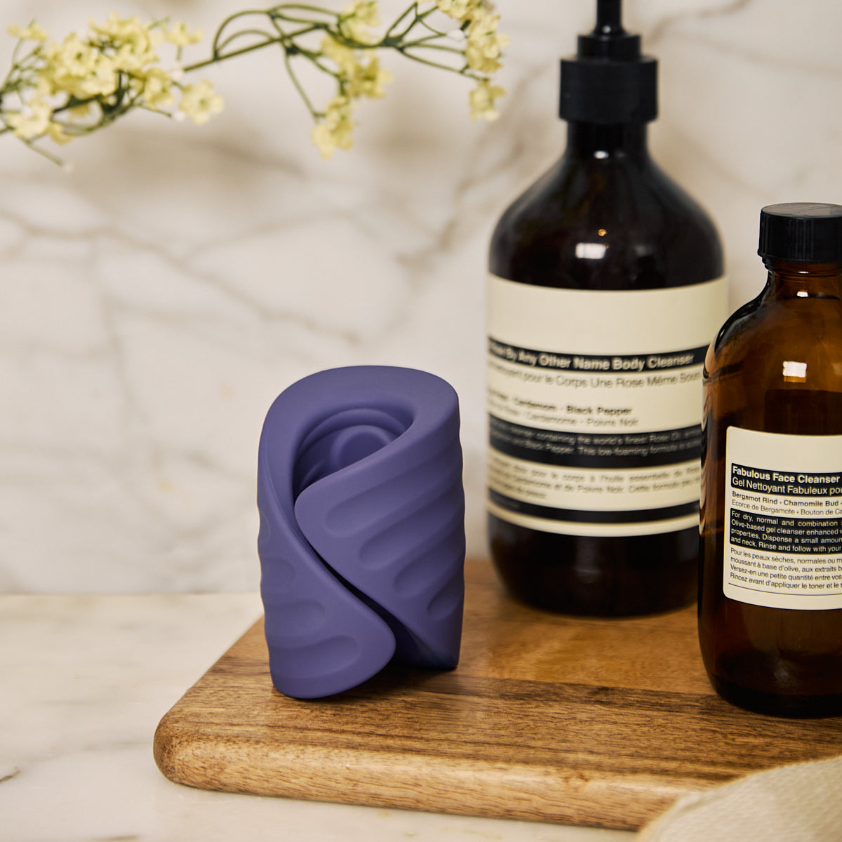 Velvet Rituals Eon app-connected massager with textured inner sleeve, shown in a calm lifestyle setting