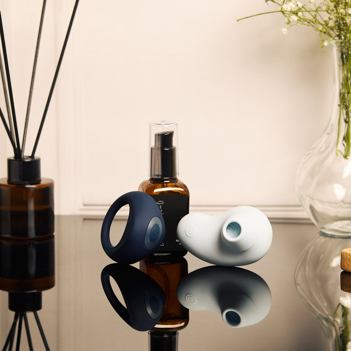 Velvet Rituals Orion and Aurora placed with premium lubricant in a minimalist lifestyle setting, highlighting compatibility, comfort, and everyday intimacy