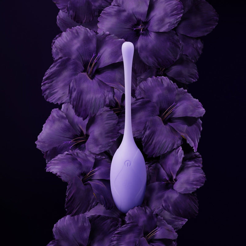 Velvet Rituals Pearl internal massager displayed as a hero shot against deep purple florals, highlighting its elegant design and discreet form
