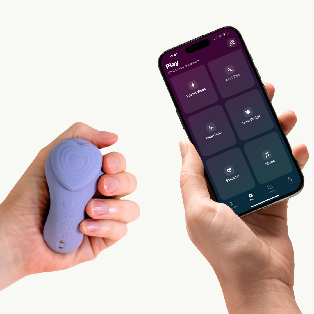 Hand holding a lavender Velvet Rituals handheld peronal wearable massager for women next to a smartphone displaying Velvet Vibes app interface.