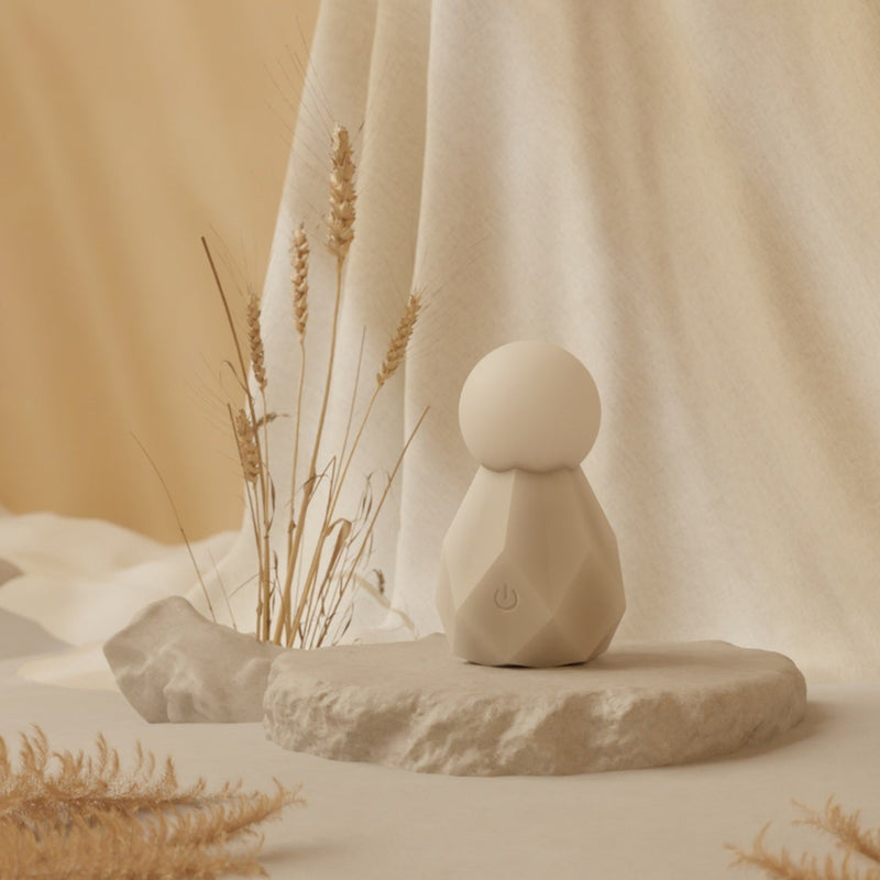 Velvet Rituals Estelle compact silicone massager displayed as a hero product shot with minimalist design and soft neutral background