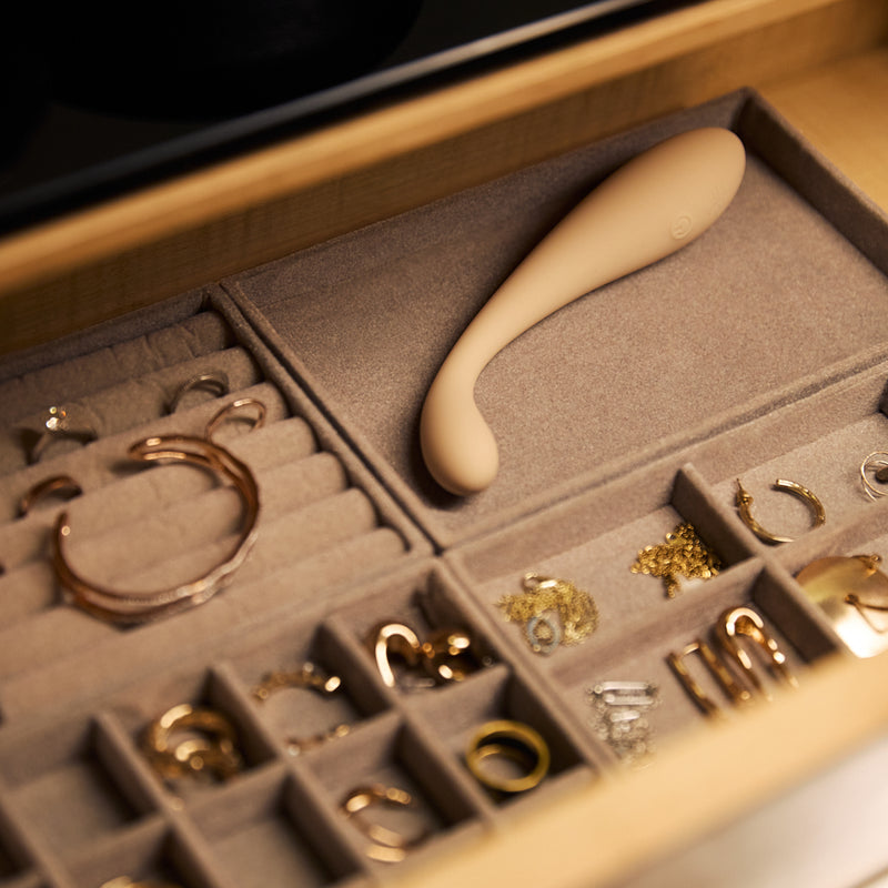 Velvet Rituals Celeste massager placed inside a jewelry organizer drawer, blending discreet design with everyday personal accessories