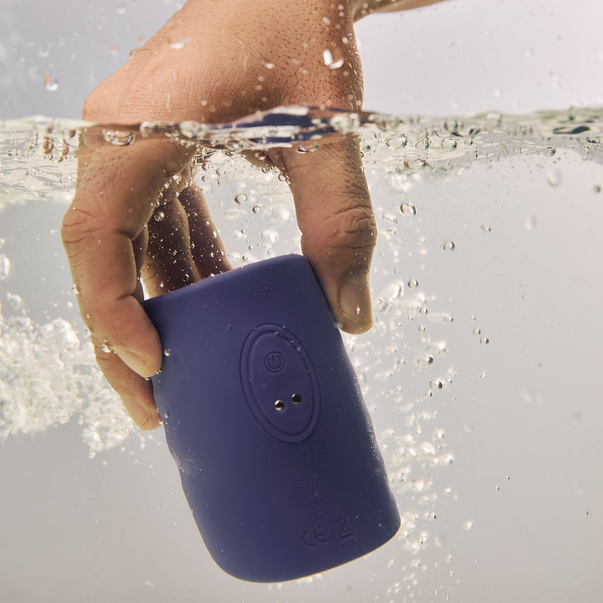 Velvet Rituals Eon handheld male massager shown underwater, highlighting its fully waterproof and submersible design for use in the shower or bath