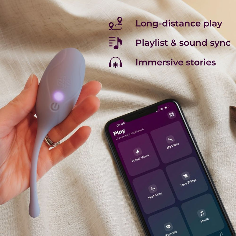 Velvet Rituals Pearl app-controlled internal massager shown with the Velvet Vibes app on a smartphone, highlighting long-distance play, immersive stories, and playlist-based sound synchronization